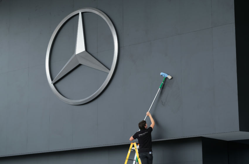FRANKFURT AM MAIN, GERMANY - SEPTEMBER 09: A worker cleans the area around a giant logo of German automaker Mercedes-Benz prior to the Mercedes-Benz media preview at the 2019 IAA Frankfurt Auto Show on September 09, 2019 in Frankfurt am Main, Germany. The IAA will be open to the public from September 12 through 22. (Photo by Sean Gallup/Getty Images)