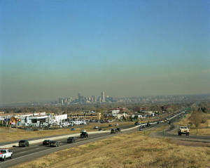Brown smog cloud danging over urban Denever with traffic and buildings in the background